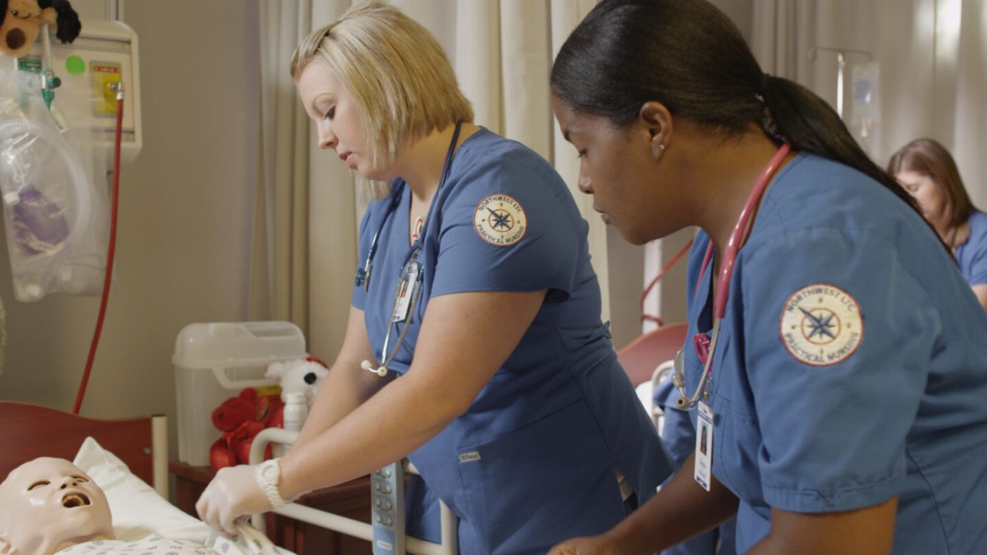 2 nurses helping a patient