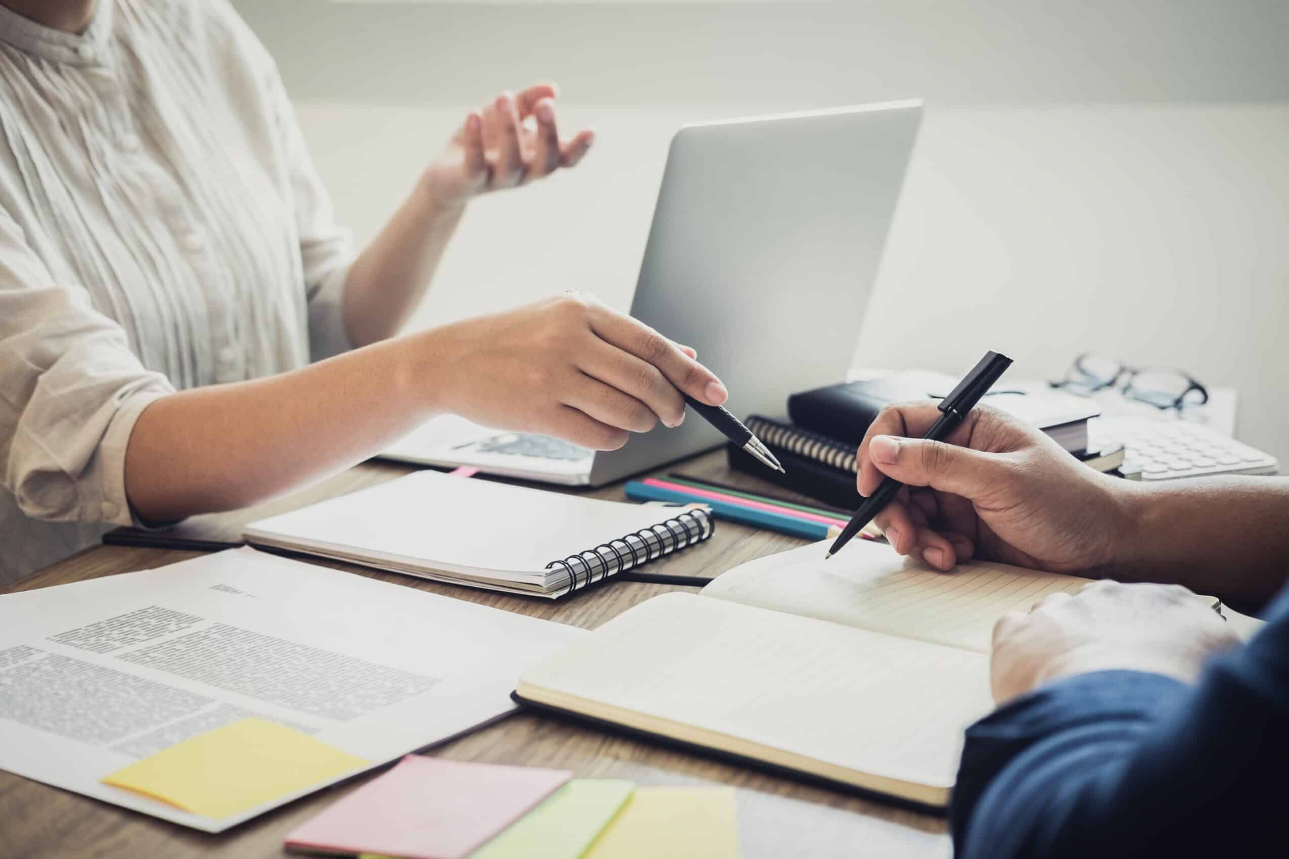 Two high school students campus or classmates with helps friend studying for a test an exam in workbook learning in classroom, Tutor books with friends, Education school concept.