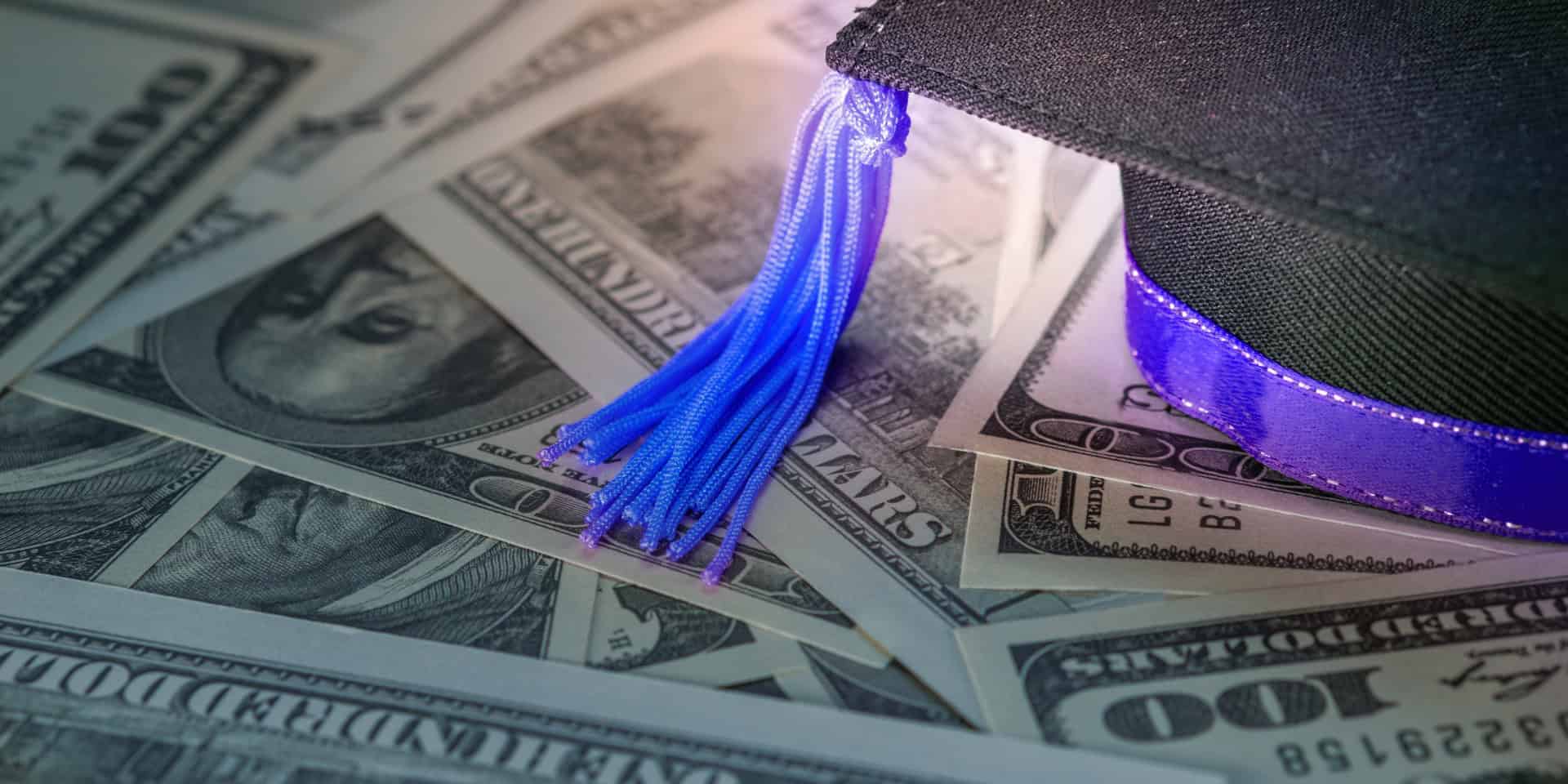 Graduation cap on top of money