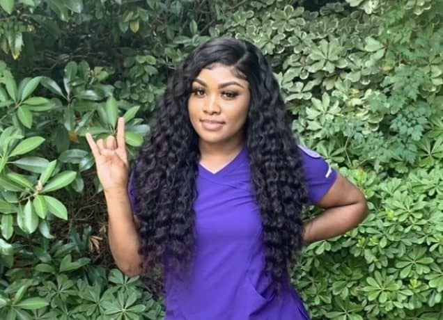 Image of Quaniqua holding up a school spirit gesture with her hands