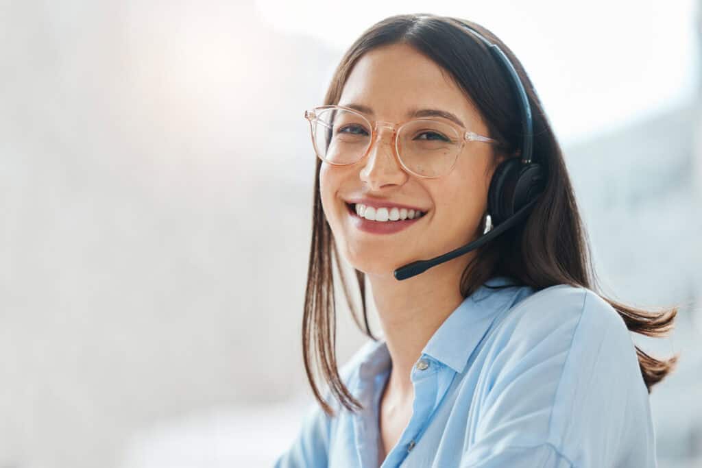 Shot of an attractive young saleswoman sitting alone in the office and wearing a headset.