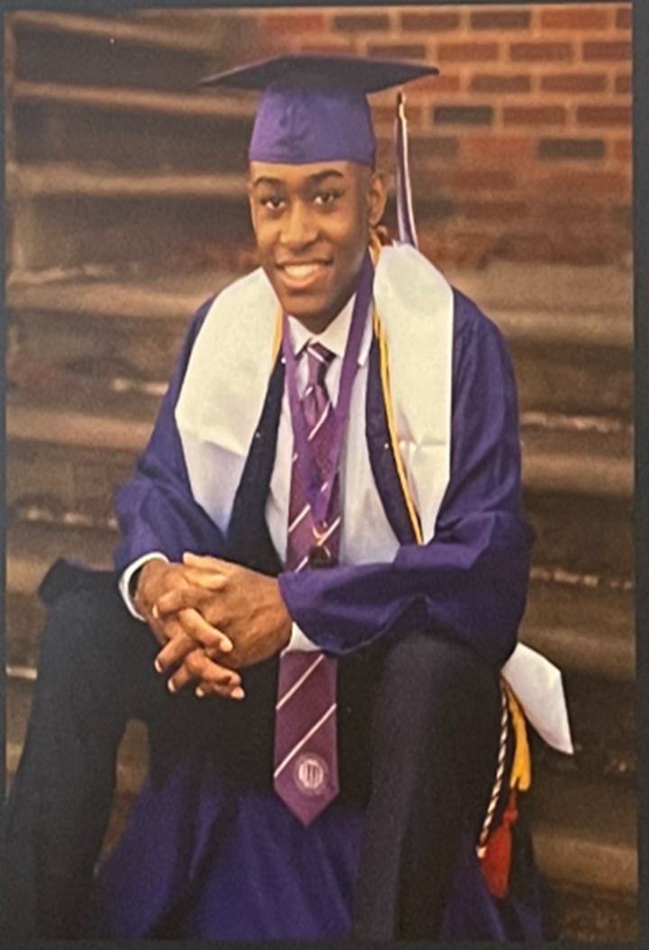 Nicholas Carter in a cap and gown